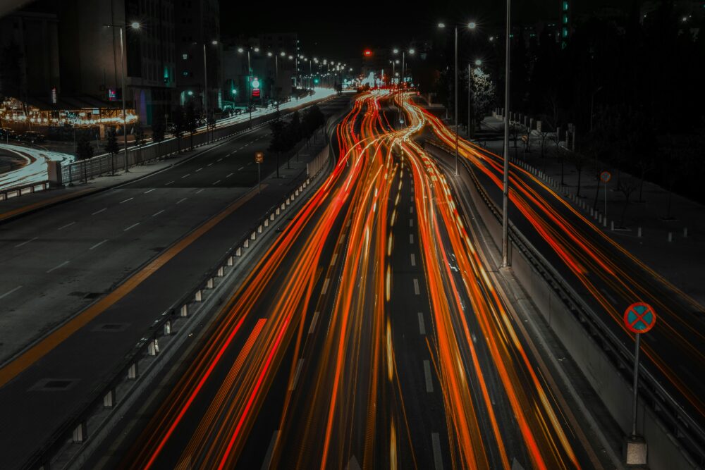 Vibrant city highway at night with dynamic light trails from fast-moving vehicles