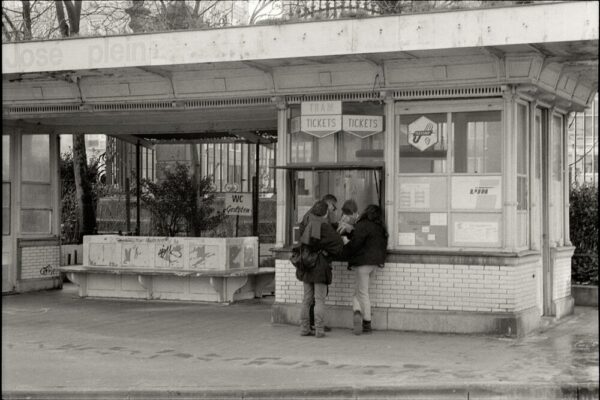 Vintage tram ticket booth with people buying tickets in black and white