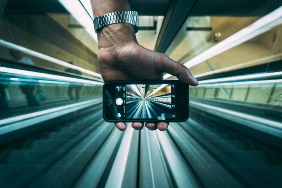 Creative shot showing an escalator view through a smartphone lens, highlighting dynamic perspective