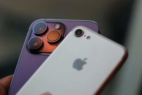 Detailed image of two modern smartphones highlighting their camera lenses and design.