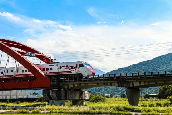 High-speed train on a red bridge in scenic Taiwan
