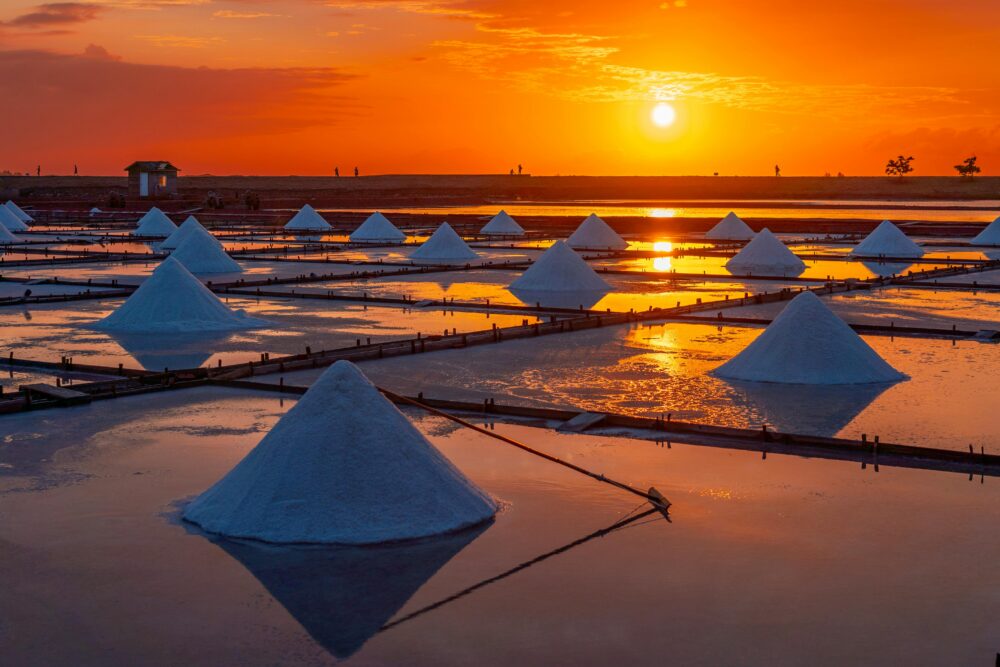 Stunning view of salt mounds at Tainan salt pans during a vibrant sunset