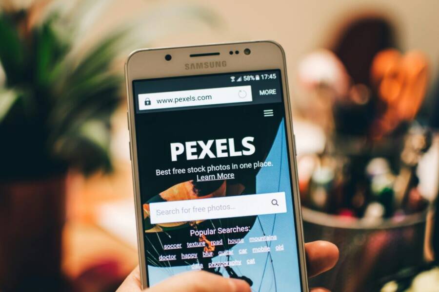 A close-up view of a smartphone displaying the Pexels stock photo search screen