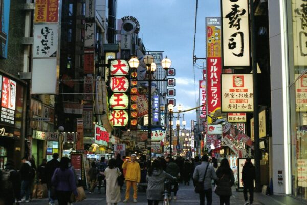 Explore the bustling streets of Dotonbori in Osaka, Japan, illuminated by traditional neon signs.