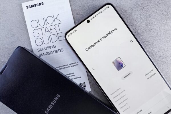 Samsung smartphone displaying settings with a quick start guide on a textured surface
