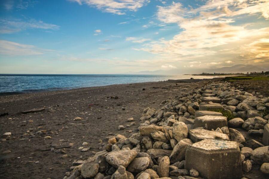 Beautiful rocky shoreline at sunset in Taitung, Taiwan with a serene ocean view.