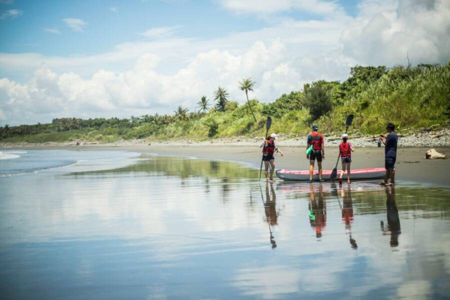 A family enjoys paddling on a picturesque beach in Taitung, Taiwan