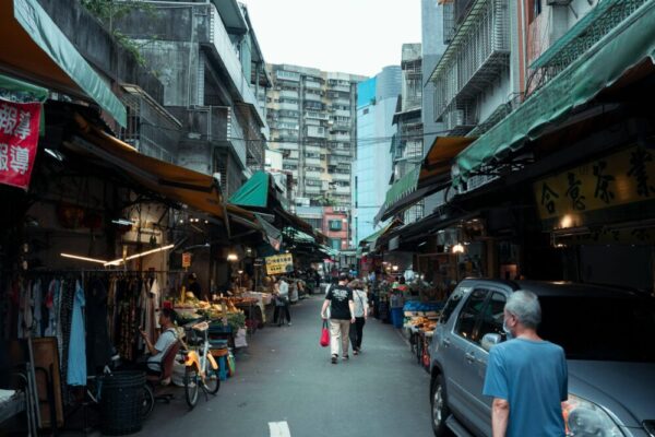 Bustling Taipei street market with shops, people, and urban vibe