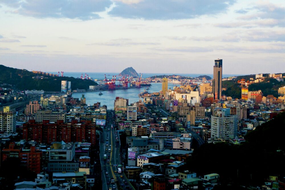 Panoramic view of Keelung cityscape with harbor and skyline under clear skies, Taiwan.