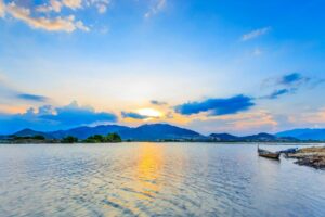 Beautiful sunset over a serene mountain lake with reflections on the water