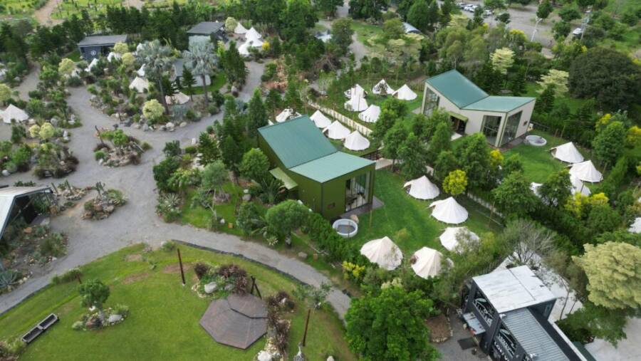 Aerial view of a modern resort with lush greenery and tent structures in Taiwan.