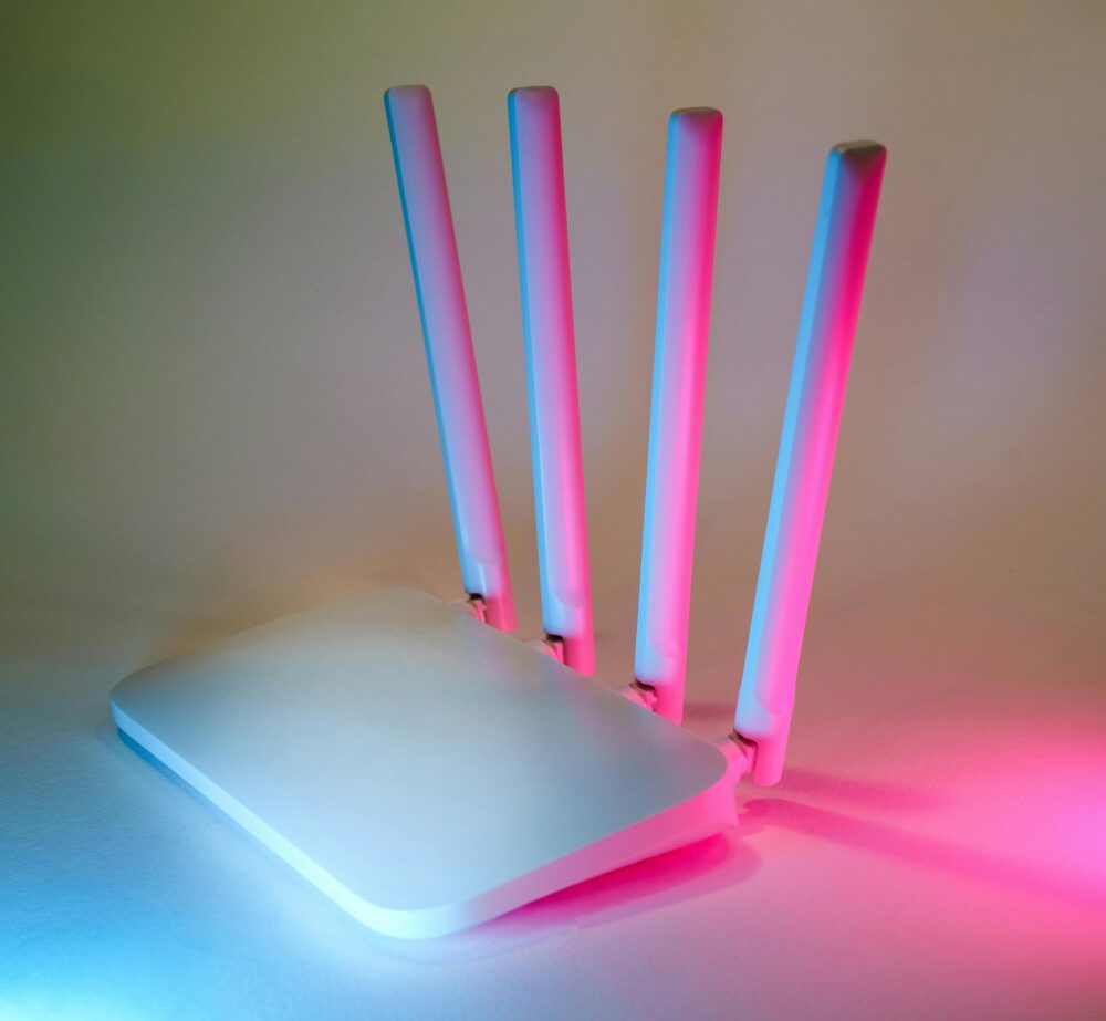 A sleek wireless router enhanced by vibrant neon lights, showcasing cutting-edge technology