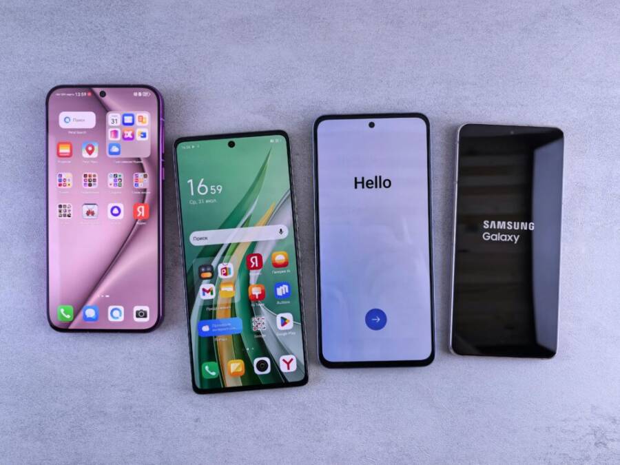 Four modern smartphones showcasing home screens, applications, and startup logos on a sleek surface
