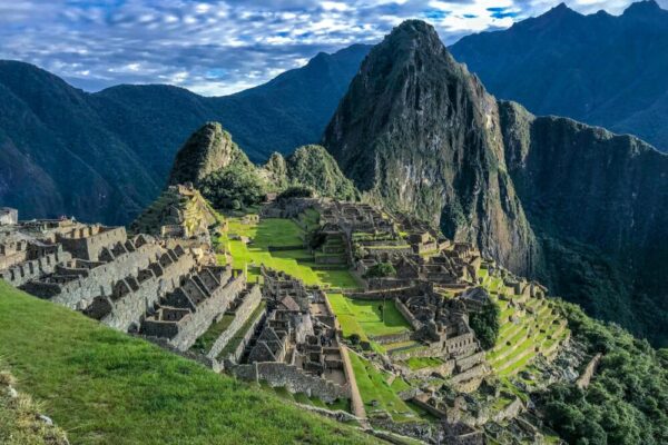 Explore the stunning ancient ruins of Machu Picchu, a UNESCO World Heritage Site in Peru, surrounded by majestic mountains.