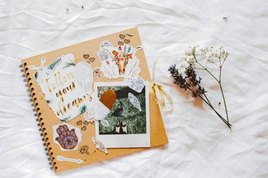 A dreamy scrapbook layout with floral decorations and motivational cutouts