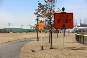 Detour signs in a New York park guiding bicycles and pedestrians.