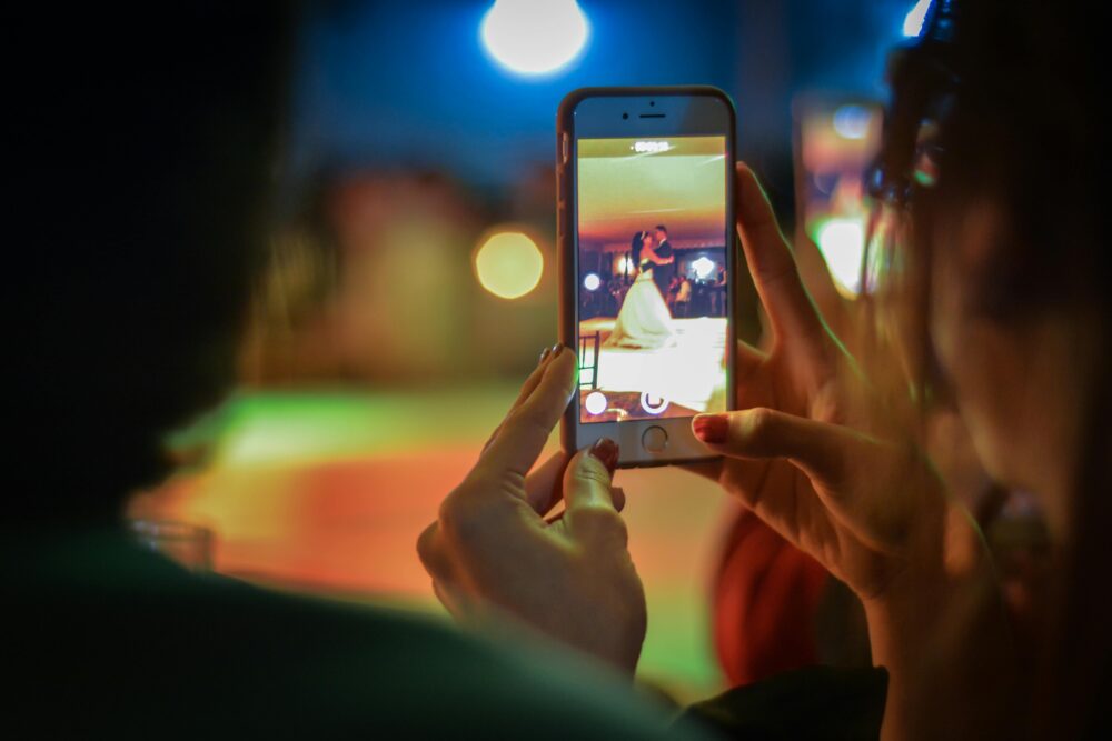 Close-up of a smartphone filming a wedding dance, highlighting modern celebration moments.