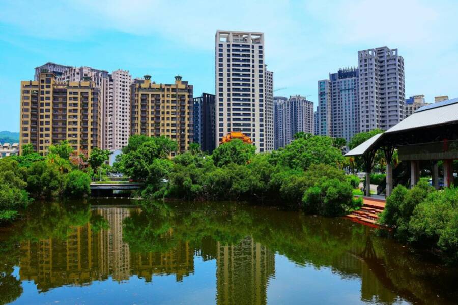 Stunning view of high-rise buildings reflecting in a pond in Kaohsiung City, Taiwan.