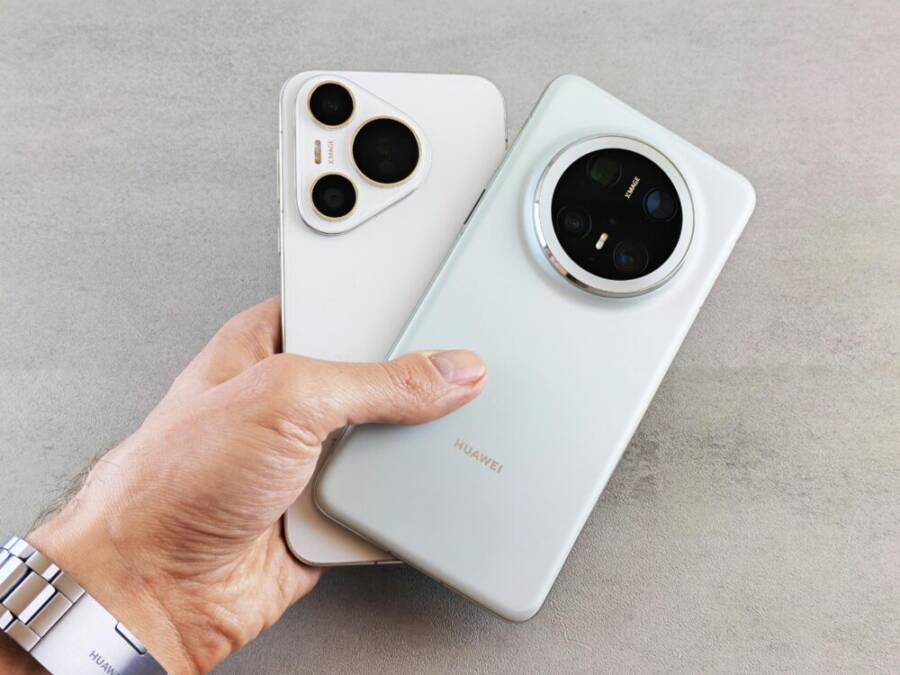 Close-up of a hand holding two modern smartphones, showcasing their sleek design