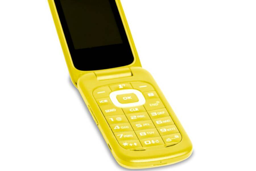 A vibrant yellow flip phone evokes nostalgia and retro communication technology.