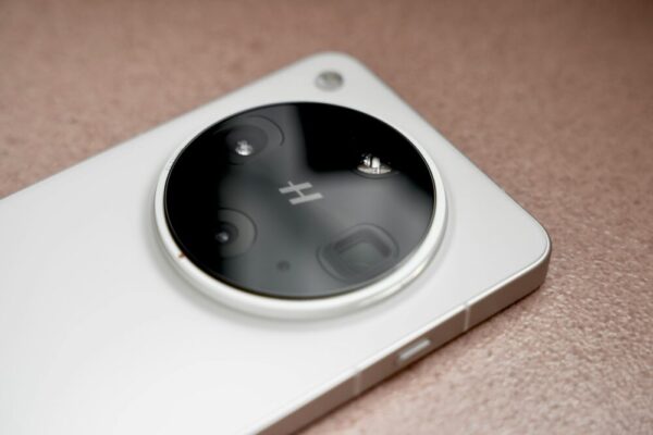 A detailed view of a smartphone camera lens in a minimalist design, emphasizing technology.