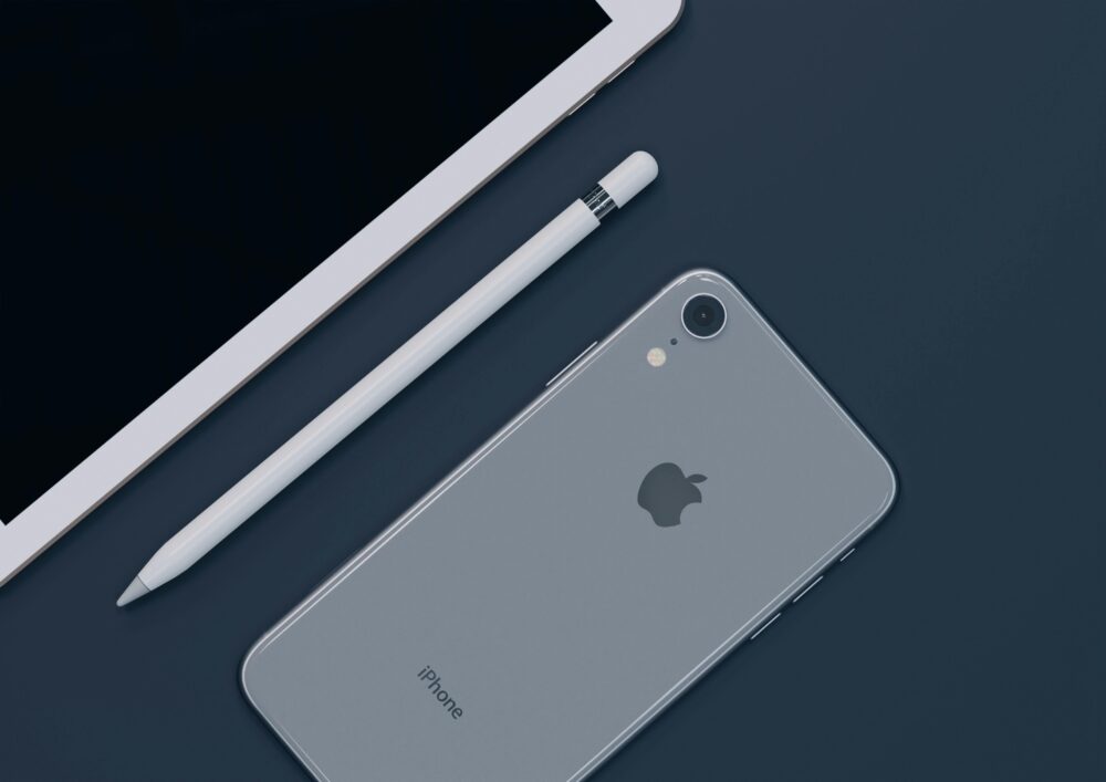Sleek design of Apple iPhone, iPad, and Pencil highlighting modern technology