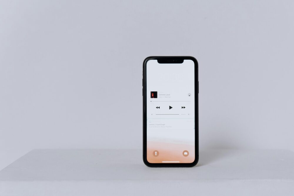 A minimalist smartphone displaying a music app set against a white background