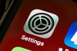 Detailed view of the iPhone screen showing the settings app icon
