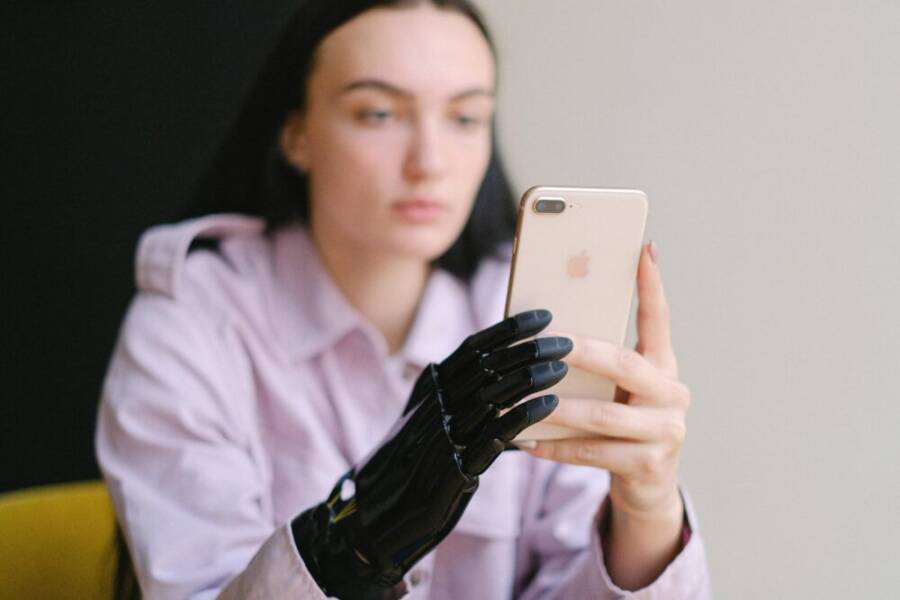 A user interacts with a smartphone in a well-lit indoor setting