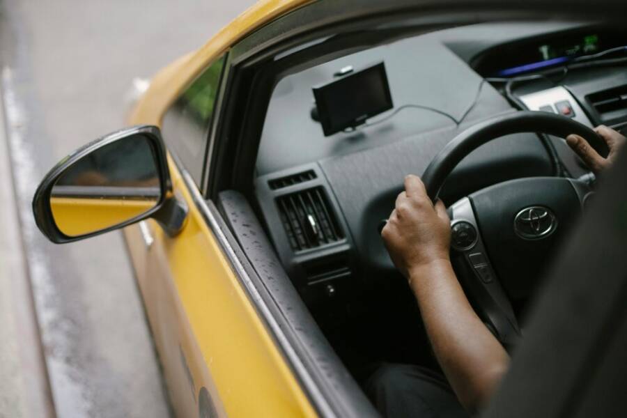 Driver with navigation on the dash of a taxi