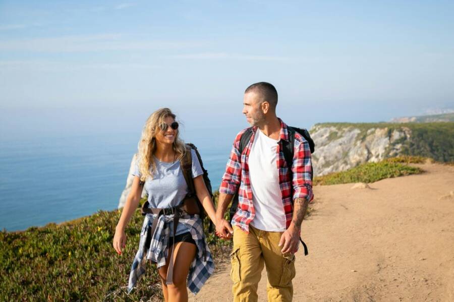 Couple enjoying a scenic hike along the stunning cliffs in Portugal