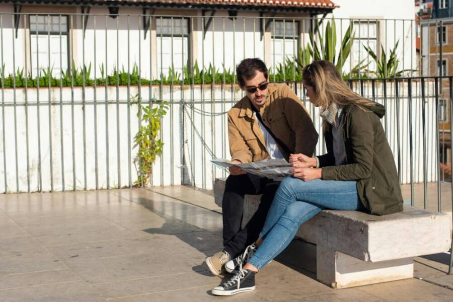 A couple planning their trip on a sunny day