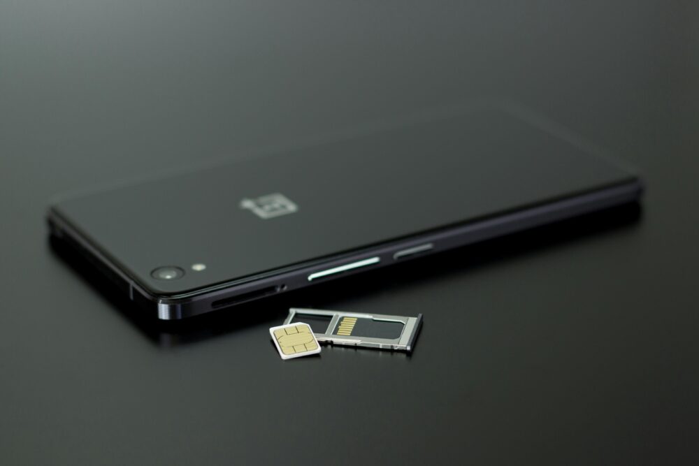 Close-up of a smartphone with a SIM card and memory card, showcasing modern technology