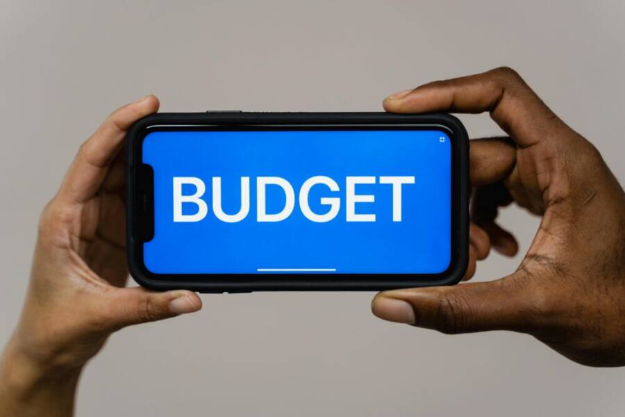 Budget phone in hand demonstrating affordability and practicality