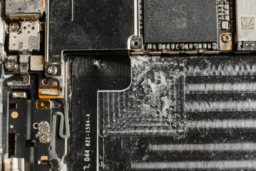 Detailed close-up of a dusty mobile phone circuit board showcasing various electronic components