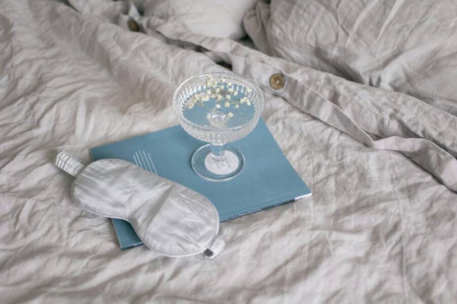 A calm bedtime setup with a sleep mask and book