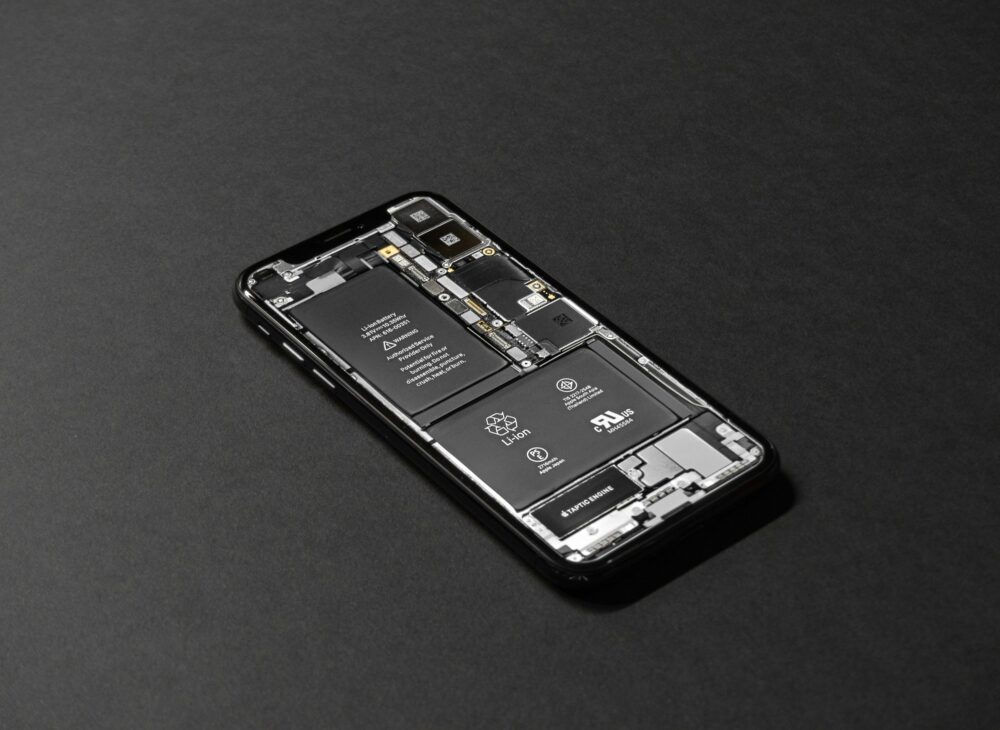 High-resolution image of a smartphone showcasing its internal components on a dark surface