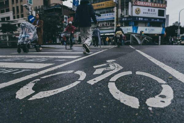 Busy urban street scene in Taiwan with bicycle lane markings and pedestrians crossing