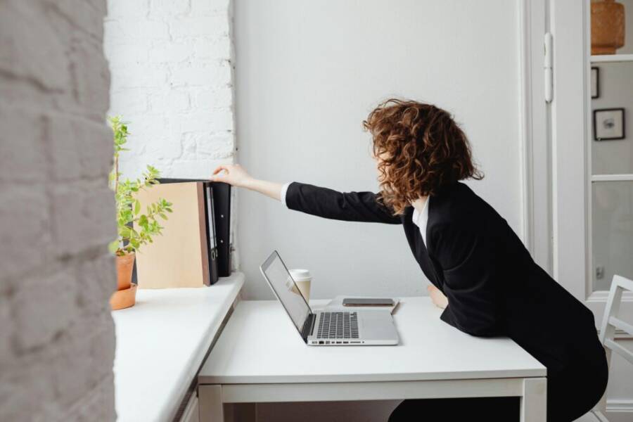 Organized folders on desk with laptop and phone