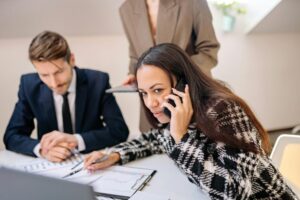 Professional meeting with focused teamwork and phone communication.