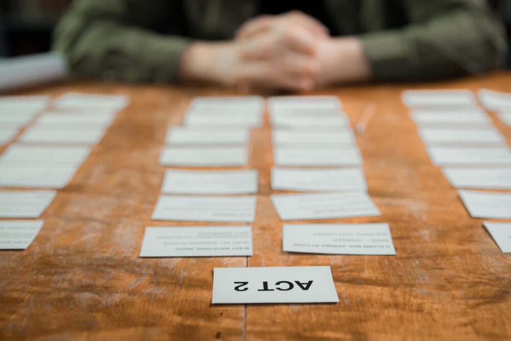 Close-up of storyboard cards arranged on a table for scriptwriting planning