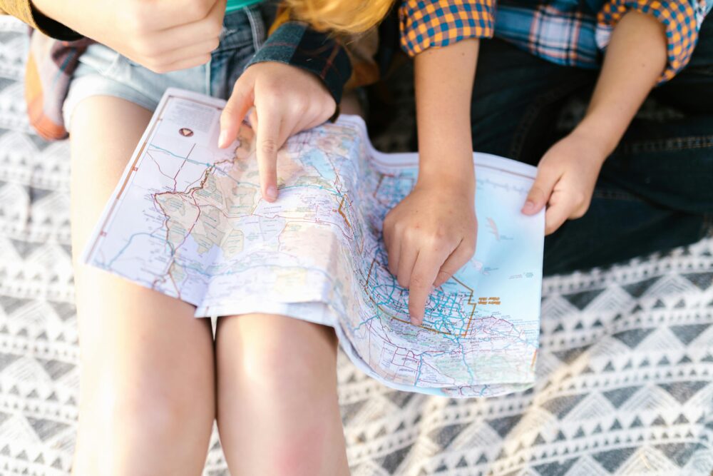 Two children planning a route on a map