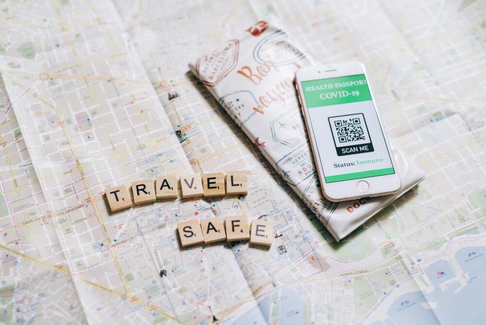 Travel safely with a health passport app displayed on a smartphone over a map.