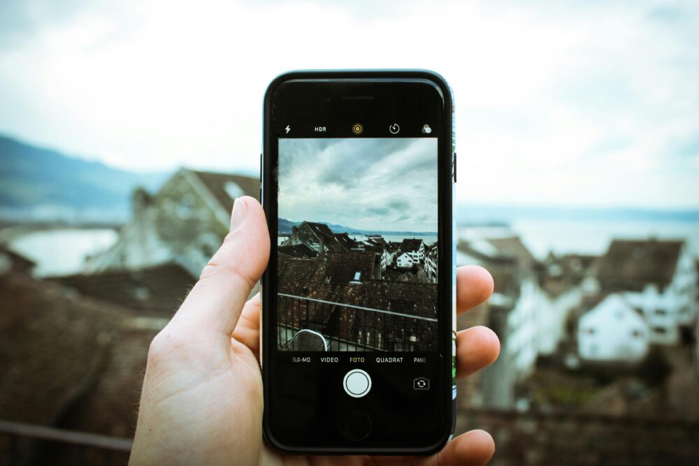 A smartphone captures the picturesque landscape