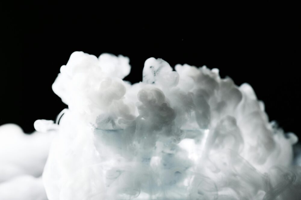 A captivating image of white smoke cloud against a dark background, creating an ethereal and mysterious visual effect