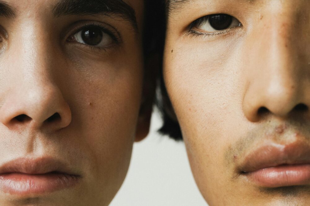 image: Close-up portrait showing diverse male faces side by side, focusing on eyes and expressions