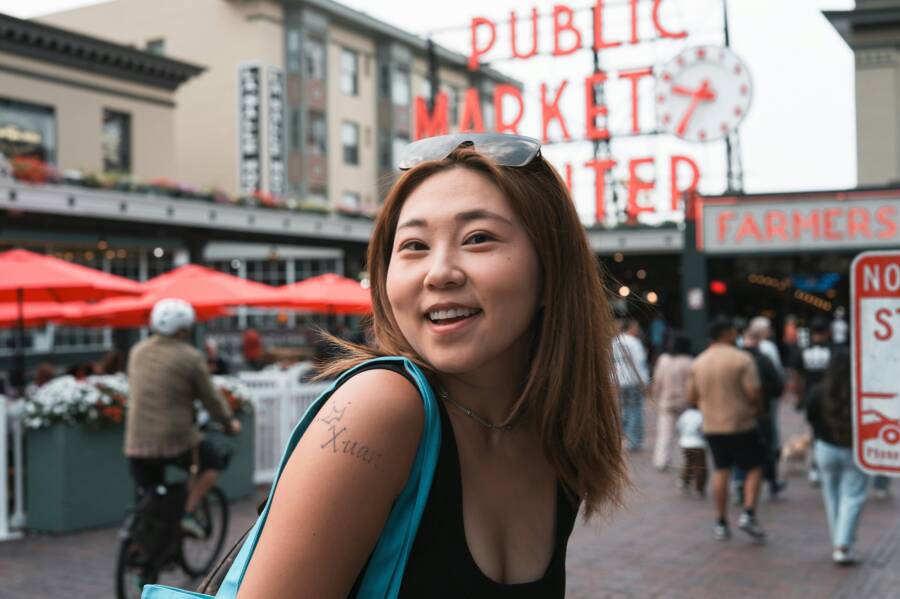 西雅圖派克市場（Pike Place Market）的微笑女士，背景是標誌性的市場標誌。
