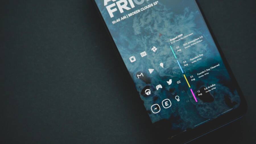Close-up of a smartphone with a custom digital interface and various icons