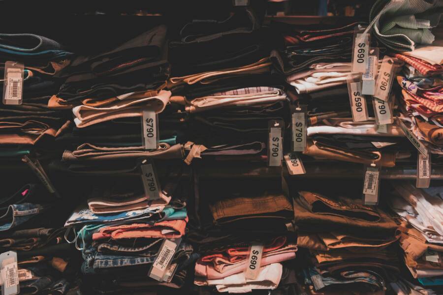 Neatly folded clothes with price tags on shelves in a Taipei shop