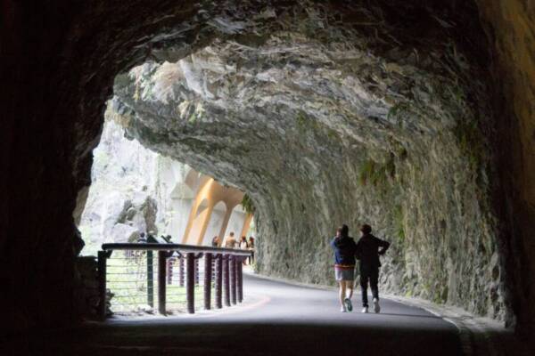 Tourists explore the scenic Shakadang Trail tunnel in Taroko National Park, Taiwan.